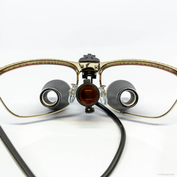 TTL loupes with light folded back and gold frame by UKloupes