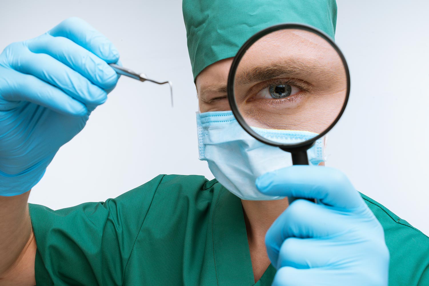 dental surgeon looking through magnifying glass